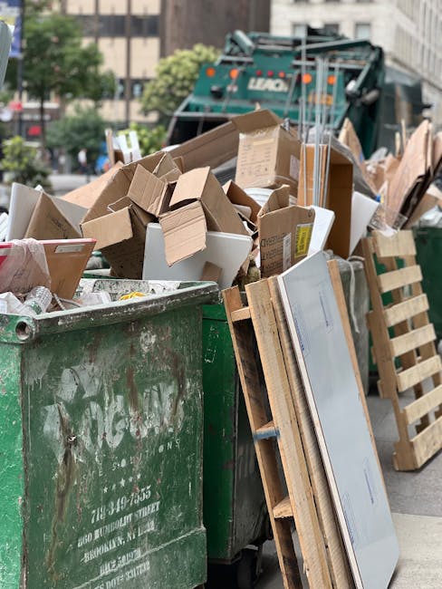 An outdoor scene showing a large amount of mixed waste and rubbish spilling onto a gravel surface, with three individuals actively sorting through the debris. The waste includes numerous black and whi
